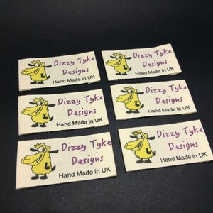 May include: Six white fabric labels with a cartoon sheep and the text "Dizzy Tyke Designs Hand Made in UK" printed in purple.