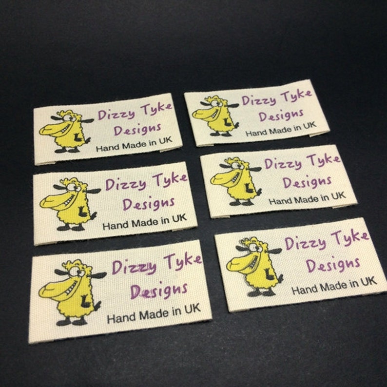 May include: Six white fabric labels with a cartoon sheep and the text "Dizzy Tyke Designs Hand Made in UK" printed in purple.