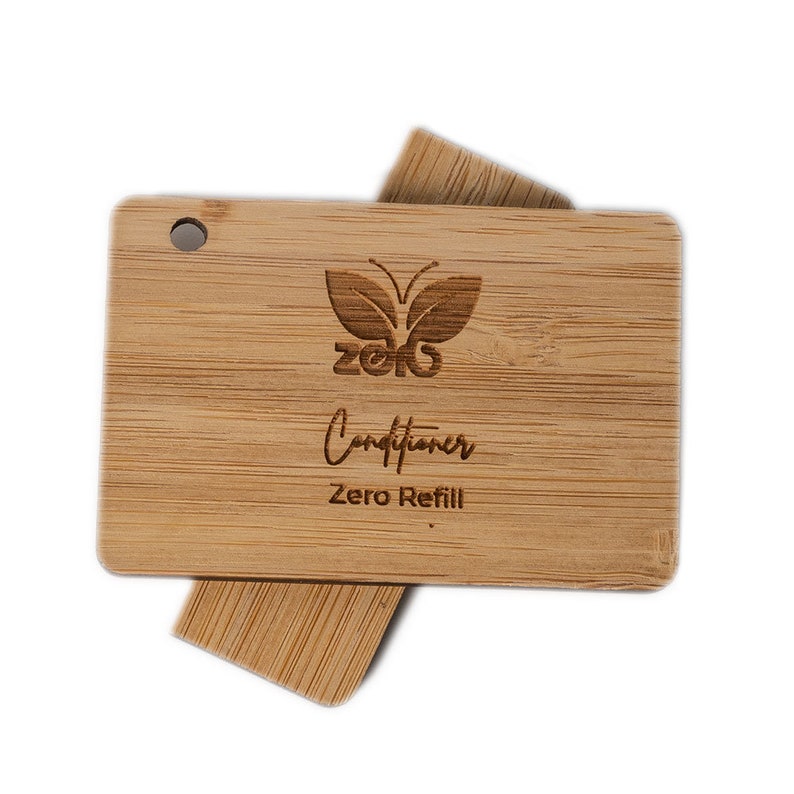 May include: A wooden conditioner bar container with a butterfly logo and the text "Zero Refill" engraved on it.