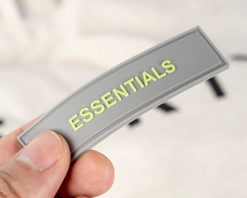 May include: A gray label with the word "ESSENTIALS" printed in yellow.