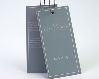 May include: A gray tag with white text and a black hole. The tag says "LARA LAUREN" and "Made in Italy".