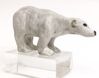 Patrick the young polar bear handmade ceramic sculpture mounted on a acrylic ice cube block.