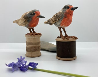 Sculptural handmade ceramic robins on vintage cotton reels