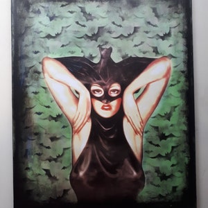 May include: A painting of a woman wearing a black bat costume with a mask over her eyes. The background is a green and black pattern of bats.