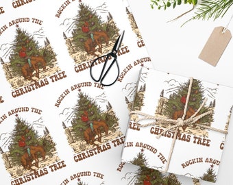May include: White wrapping paper with a repeating pattern of a Christmas tree with a cowboy hat and the text "Rockin' Around the Christmas Tree".
