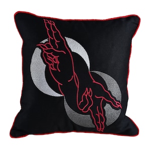 May include: Black pillow with red embroidered hands and silver embroidered circles.