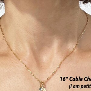May include: A 16-inch gold cable chain necklace on a person's chest. The text "16" Cable Chain Shown (I am petite/5'3")" is below the chain.