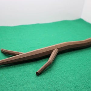 May include: A white ceramic mug with a black handle and the text "But First, Coffee" in a bold, black font. The mug is set against a blurred background, highlighting its clean design.