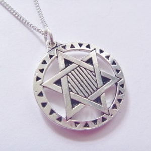 May include: A silver necklace with a pendant featuring a six-pointed star, also known as the Star of David, surrounded by a circle of triangles.