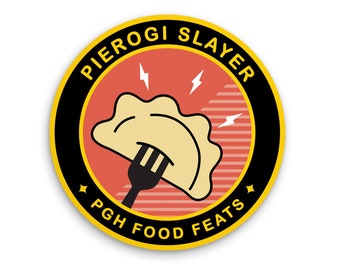 May include: A yellow and black circular sticker with the text "Pierogi Slayer PGH Food Feats" and a cartoon image of a pierogi being pierced by a fork.