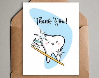 May include: A white card with a blue background and a cartoon tooth holding a toothbrush. The text "Thank You!" is written in black on the card.