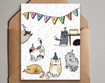 May include: A greeting card with a white background and colorful confetti. The card features a banner that says "CONGRATS" and several cats wearing party hats. The cats are in various poses, including one cat holding a piece of cake.