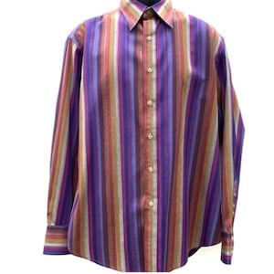 May include: A long-sleeve button-down shirt featuring a vertical striped pattern in shades of purple, red, orange, and light blue. The shirt has a pointed collar, a front button placket with light-colored buttons, and buttoned cuffs on the sleeves.