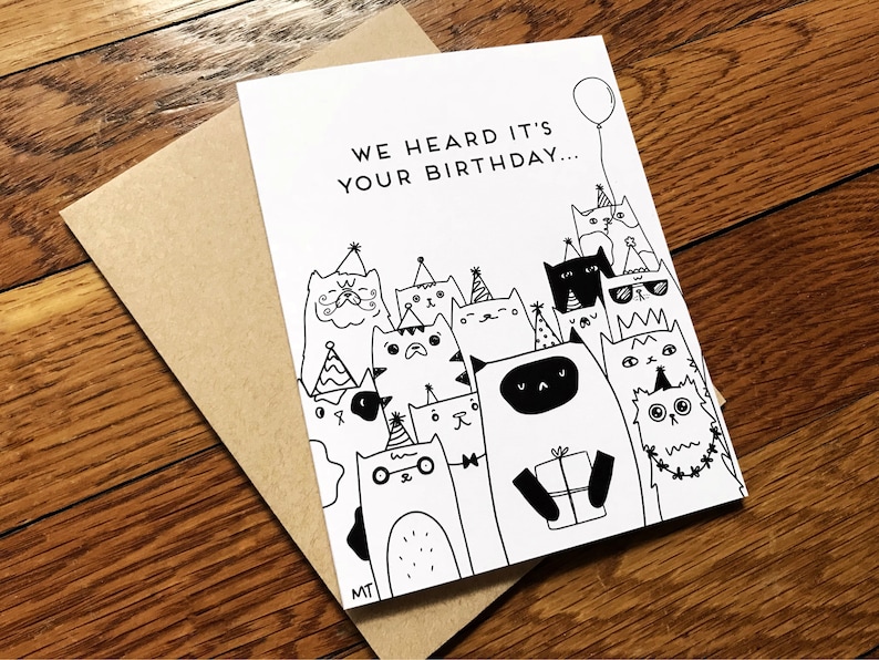 May include: A black and white birthday card with the text "We heard it's your birthday..." and a group of cats wearing party hats and holding a gift.