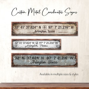 May include: Three rustic wooden signs with metal accents, each displaying the coordinates 32° 41' 37.824" N 97° 7' 21.216" W and the text "Arlington, Texas".