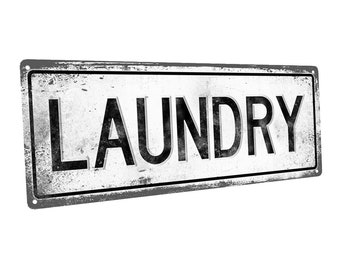 May include: A white metal sign with black lettering that reads "LAUNDRY". The sign has a distressed, vintage look.