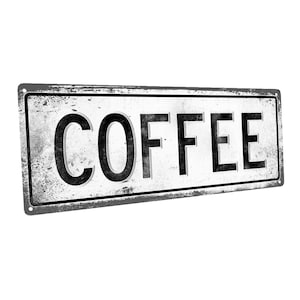 May include: A vintage-style metal sign with a distressed white background and black lettering that reads "COFFEE".
