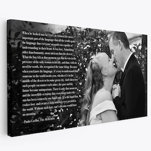 May include: Black and white photo of a couple looking at each other with a quote from Paulo Coelho's The Alchemist: "When he looked into her eyes, he learned the most important part of the language that all the world spoke... It was love. Something older than humanity, more ancient than the desert..."
