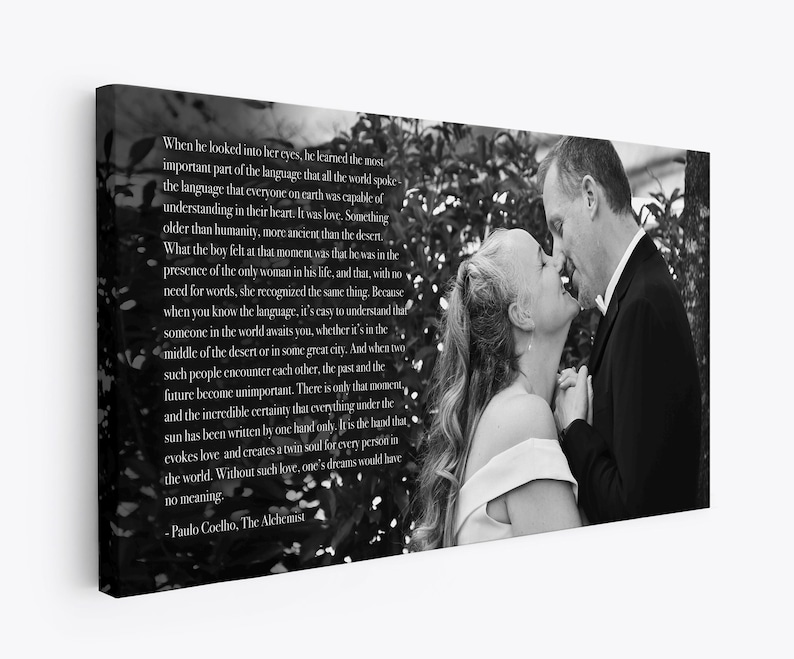 May include: Black and white photo of a couple looking at each other with a quote from Paulo Coelho's The Alchemist: "When he looked into her eyes, he learned the most important part of the language that all the world spoke... It was love. Something older than humanity, more ancient than the desert..."