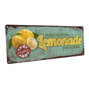 May include: Vintage-style metal sign with a distressed teal background. The sign features illustrations of lemons and the words "FRESH SQUEEZED Lemonade 100% NATURAL." A red and white stamp reads "ICE COLD!"