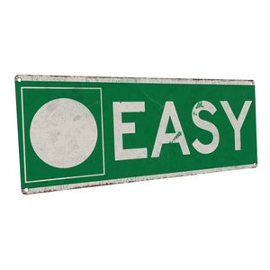 May include: Green metal sign with a white circle and the word "EASY" in white letters.
