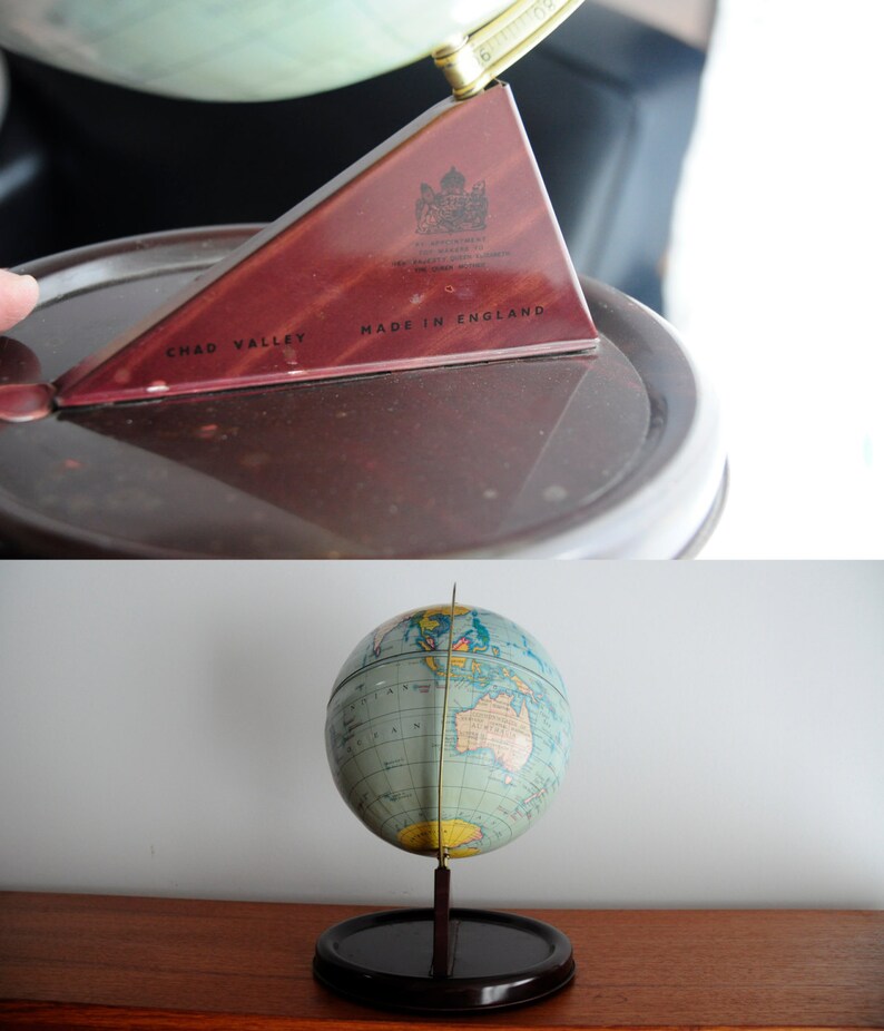 May include: A vintage globe with a blue and green map of the world. The globe is on a black stand with a wooden base. The globe is made by Chad Valley and says "Made in England".