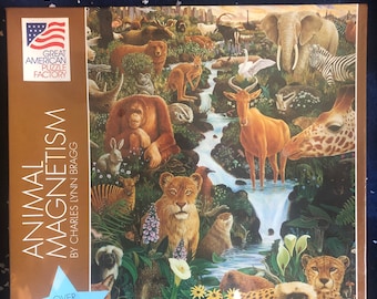 May include: A 1000 piece jigsaw puzzle featuring a colorful illustration of various animals in a lush forest setting. The puzzle is titled "Animal Magnetism" by Charles Lynn Bragg. The puzzle is made by the Great American Puzzle Factory.