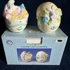 May include: A set of three ceramic mugs with a speckled, matte finish. The mugs are in shades of cream, light gray, and dark gray. Each mug has a simple, minimalist design, perfect for coffee or tea.