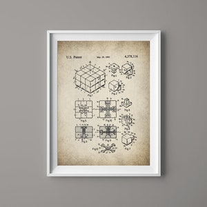 May include: A black and white line drawing of a patent for a 3D puzzle cube. The patent is dated March 25, 1963 and the patent number is 4,378,116. The drawing shows different views of the cube and its components.