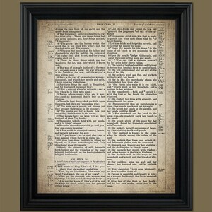 May include: A vintage framed print of a bible passage from Proverbs 31, featuring a black and white text on a cream background. The text describes the qualities of a virtuous woman.