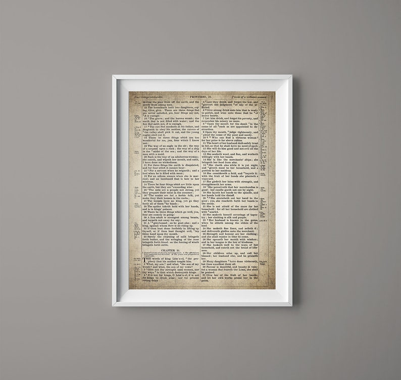 May include: A vintage, framed print of a page from the book of Proverbs in the Bible. The text is in black and white and the paper is aged and yellowed. The page is framed in a white frame.