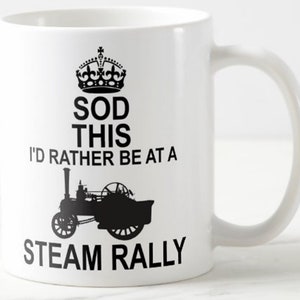 May include: White ceramic mug with a black and white design. The mug features a crown, the text "Sod This I'd Rather Be At A Steam Rally", and a silhouette of a steam engine.