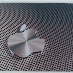 May include: A silver Apple logo on a dark grey background with a metallic finish. The background has a pattern of small, evenly spaced holes.