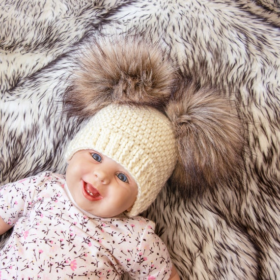 cream hat with fur pom pom