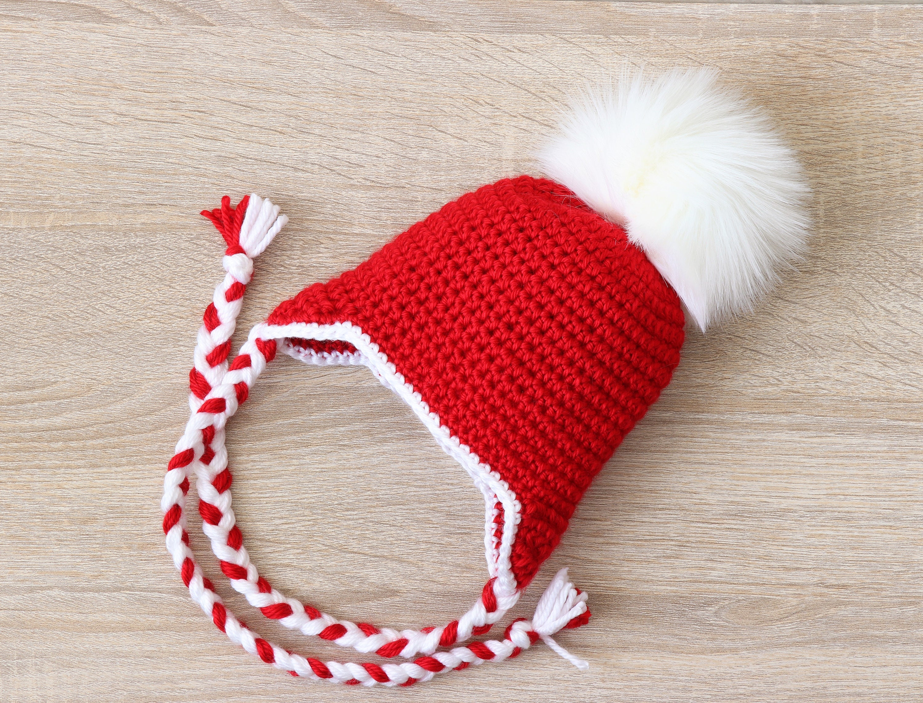 red and white pom pom hat