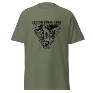 May include: A green t-shirt with a black graphic of the 2nd Foreign Parachute Regiment of the French Foreign Legion. The graphic features a dragon with wings and the text "LÉGION ÉTRANGÈRE 2e REGIMENT ÉTRANGER DE PARACHUTISTES".