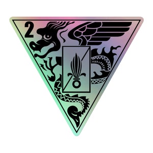 May include: A black and white triangular patch with a dragon and a fleur-de-lis design. The number "2" is in the top left corner.