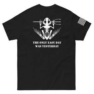 May include: Black t-shirt with a white skeleton frog holding a spear and the text "The only easy day was yesterday".