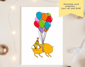 May include: A white greeting card featuring a cartoon dog holding colorful balloons. The dog wears a party hat and glasses. Text on the card reads "Instant Download" and "Greeting card template - just cut and fold!"