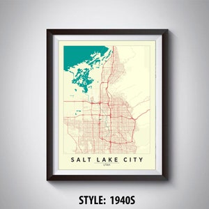 May include: A vintage style map print of Salt Lake City, Utah. The map is in a black frame and features a teal blue lake and red roads. The text "SALT LAKE CITY UTAH" is printed at the bottom of the map. The style is labelled "1940s".