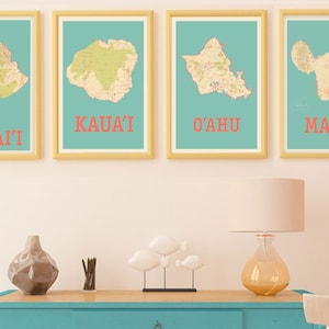 May include: Four framed maps of the Hawaiian islands, with the names "HAWAI'I", "KAUA'I", "O'AHU", and "MAUI" printed below each map. The maps are displayed on a light pink wall above a teal blue dresser.