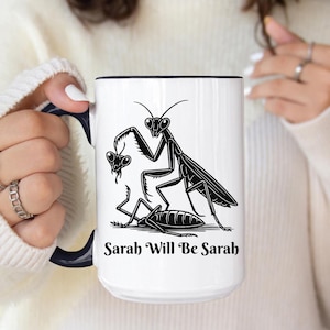May include: White ceramic mug with a black interior and handle. The mug features a black and white illustration of praying mantises and the text "Sarah Will Be Sarah".