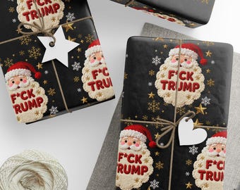 May include: Black gift wrap with a repeating pattern of gold snowflakes and stars. Each wrapped gift features a Santa Claus design with the text "F*CK TRUMP" and "F*CK RUMP". The gifts are tied with twine and adorned with white tags.