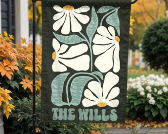 May include: A green and white garden flag with a floral design and the text "The Wills" in a retro font.