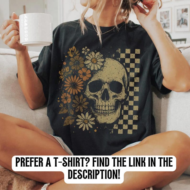 May include: Black t-shirt featuring a skull design with floral and checkered elements. The skull is surrounded by orange and yellow flowers. The text at the bottom of the image reads: PREFER A T-SHIRT? FIND THE LINK IN THE DESCRIPTION!