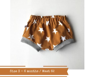 Yellow baby or toddler shorts with stars. Size 3 - 6 months