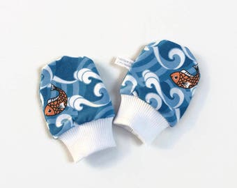 Blue baby scratch mitts with fish. Mittens with cuffs. Shower gift. Knit fabric with orange fish. No scratch mitts