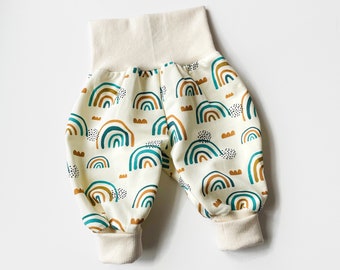 White baby pants with rainbows in green and brown. Baggy harem pants