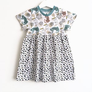 Girl's dress with leopards. Size 12 18 months White dress. White jersey fabric with leopards and leopard spots. Skater dress image 1