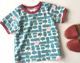 Off-white shirt with speech balloons. Kid's t-shirt in blue, pink, and red. Kid's top. cotton knit fabric. Toddler top